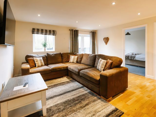 A living room with a sofa and television at Paddington Lodge in Brigg
