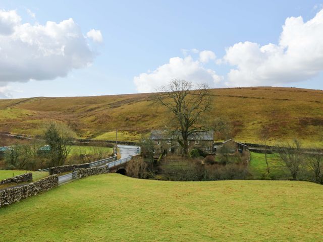 A house with a tree on a hill at Wain Wath Cottage in Richmond