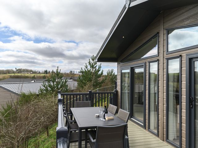 An outdoor patio with a table and chairs at Helvellyn (Pet) in Penrith