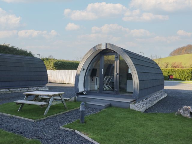 A pod with a picnic table and grass area at Pod 5 (Pet Friendly) Tewitfield