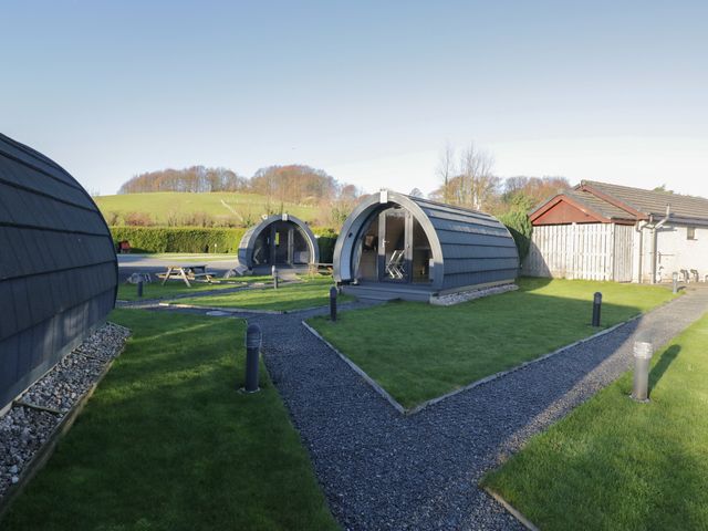 An outdoor area with glamping pods and a picnic table at Pod 7 (Pet Friendly) Tewitfield