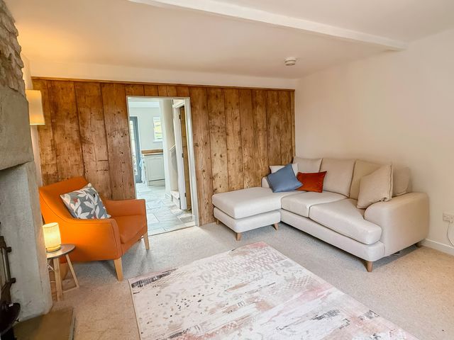 A living room with a sofa and armchair at 7 Litton Slack in Tideswell