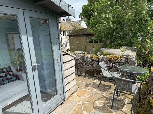 An outdoor space with a table and chairs at 7 Litton Slack in Tideswell