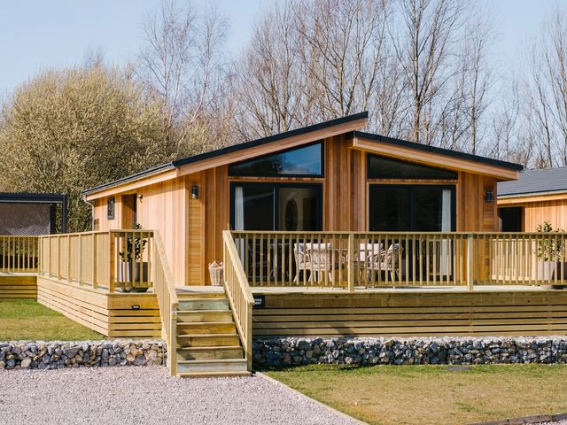 A wooden cabin with a deck and steps at The Luxury Hideaway in Waltham