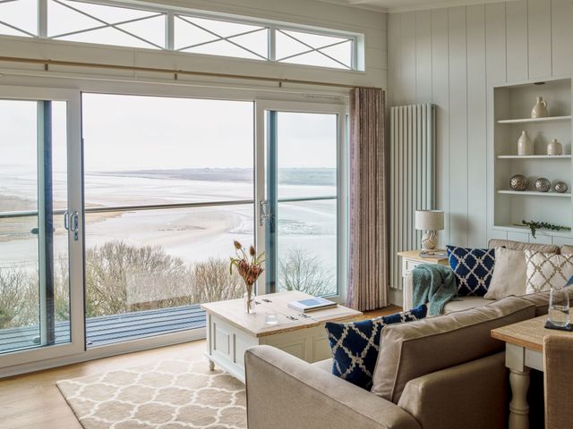 A living room with a view of the sea at Milk Wood 2 Spa in Laugharne