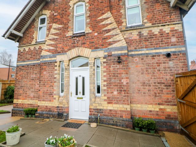 A front exterior view with door and planters at Nightingale Cottage in Stafford