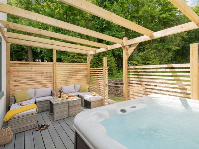 An outdoor area with seating and a hot tub at Patterdale (Pet) Penrith