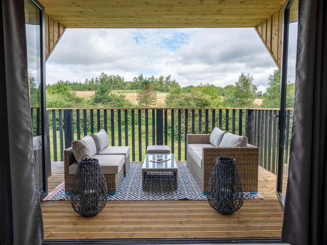 An outdoor seating area with couches and a coffee table at Orka 1.0 (Pet) Dumfries