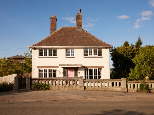 A house with two chimneys and a pink door at The White House, Riverside Retreat Bracondale
