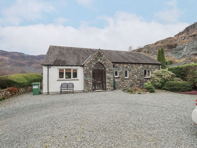 A house with gravel driveway and landscaping at Thrang View in Chapel Stile