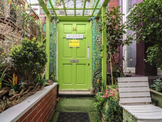 A green door with a vacancy sign in an outdoor area at Number 2 Blackpool