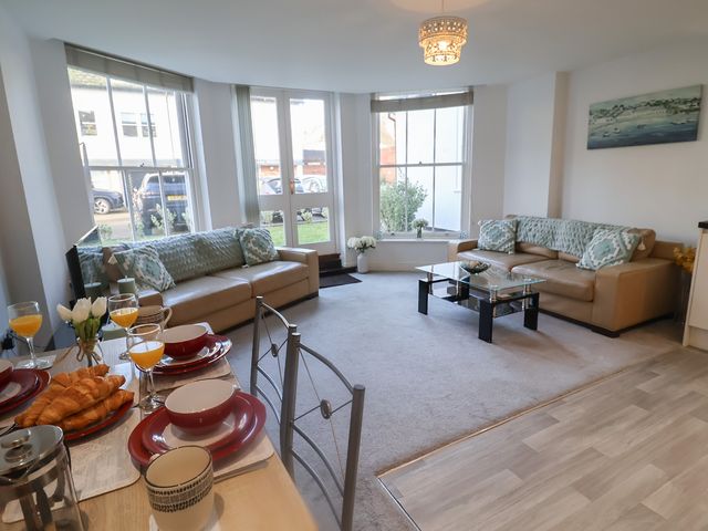A living room with a sofa and coffee table at Stylish Central Ipswich Apartment Near the Waterfront with Parking, Ipswich
