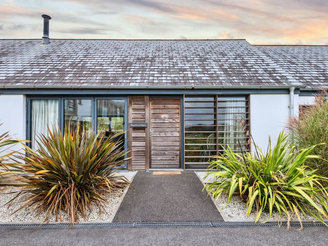 The entrance of Beachcombers Marhamchurch with plants and a pathway