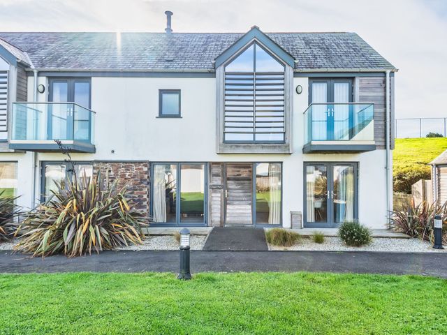 A house with balconies and plants at Chapel Park in Marhamchurch