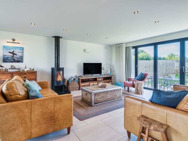 A living room with a coffee table and television at Eagle's Nest in Marhamchurch