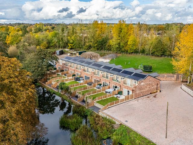 An outdoor area with townhouses and garden at 7 Riverside Mews in Derby