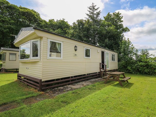A mobile home with a picnic table and seating at Caravan 2 at Blackmoor Farm near tenby Narberth