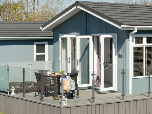 An outdoor area with a table and chairs at Kynance Spa (Pet) Bude