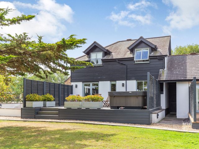 An outdoor area with a deck and hot tub at Summerleaze Garden Cottage 3 Spa, Bude