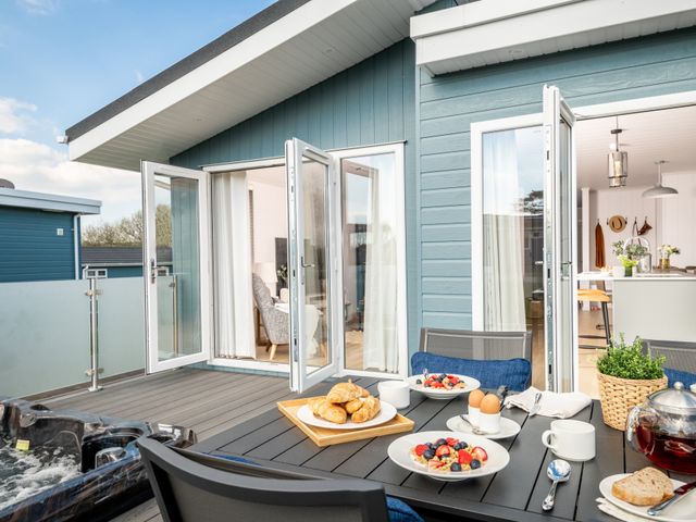 An outdoor dining area with breakfast items at Sennen 3 Spa (Pet) Bude