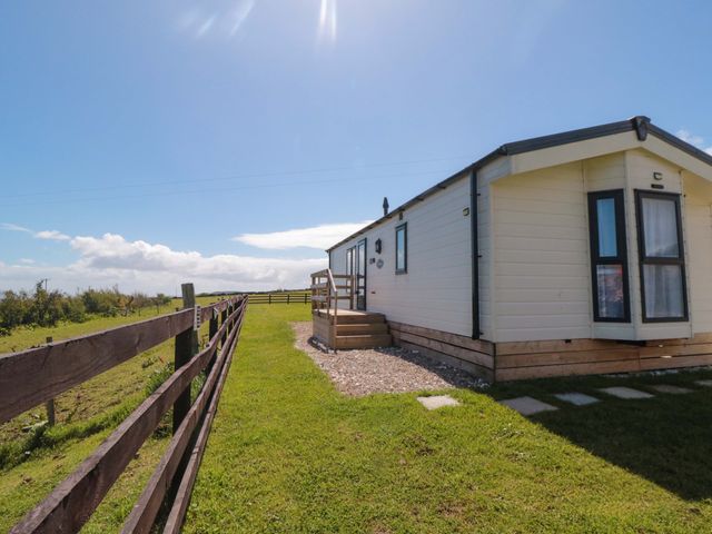 A cabin with a pathway in front at Rosefinch Cabin Staintondale near Scarborough