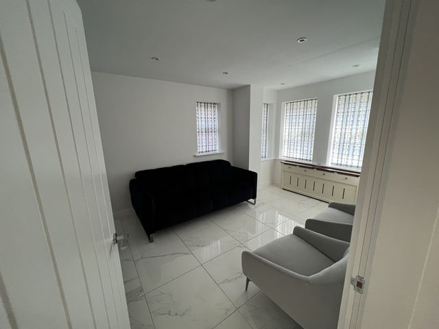A living room with a sofa and armchairs at 15A Richmond Street Ashton-under-Lyne