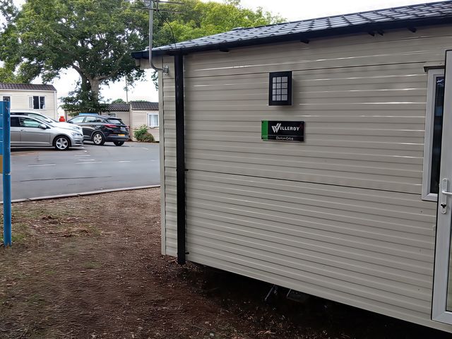 A caravan with a sign and door at Caravan Thorness Bay Holiday Park Thorness Lane