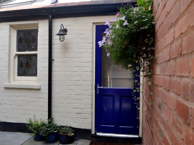 A blue door with plants near the entrance at 45 School Road Birmingham