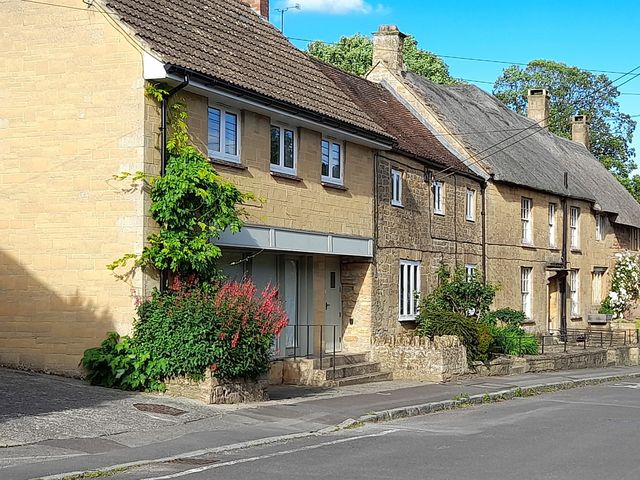 A house with a flower bed and pathway at Greenham Rise in Norton-Sub-Hamdon