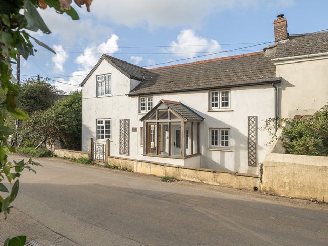 A house with windows and a front door at The Cottage in Helston