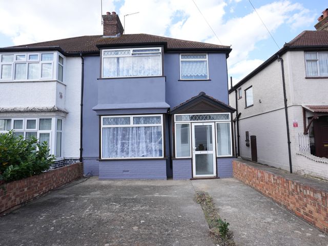 A house with windows and a driveway at Westwick Gardens Retreat Hounslow