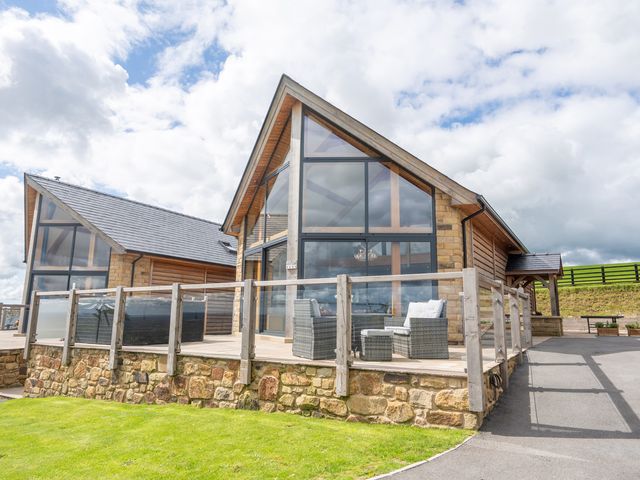 A building with large windows and a deck at Valley View Lodge 1 Preston