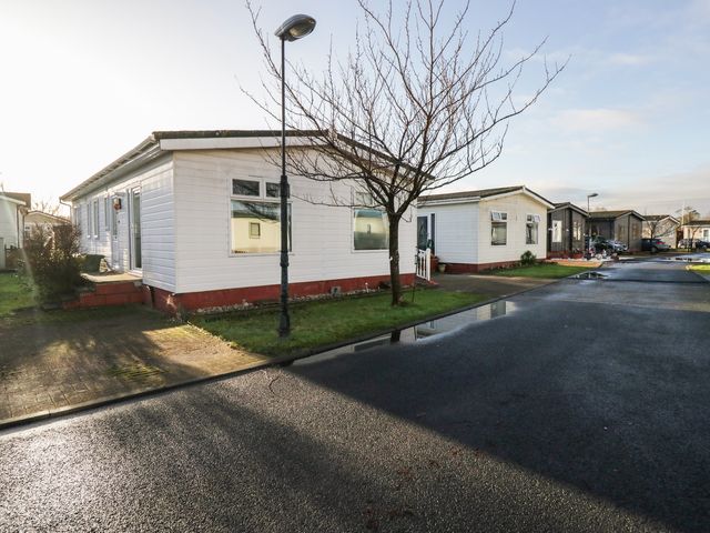 A mobile home in a park area at Beechtree Lodge 55 Denny