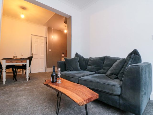 A living room with a sofa and dining table at Isla’s Sea Forge Saltburn-by-the-Sea