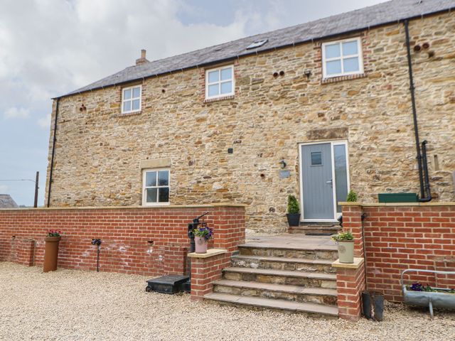 An outdoor area with steps and a stone wall at The Granary in Durham