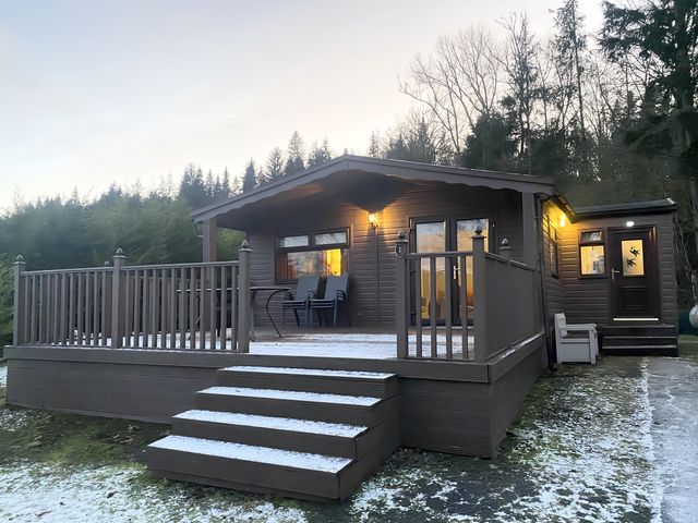 A cabin with a deck and steps at Cabin 1 Moffat Manor in Moffat