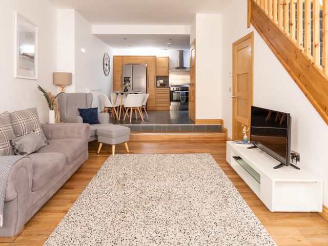 A living room with a sofa and television at 11A Cards Wynd Anstruther