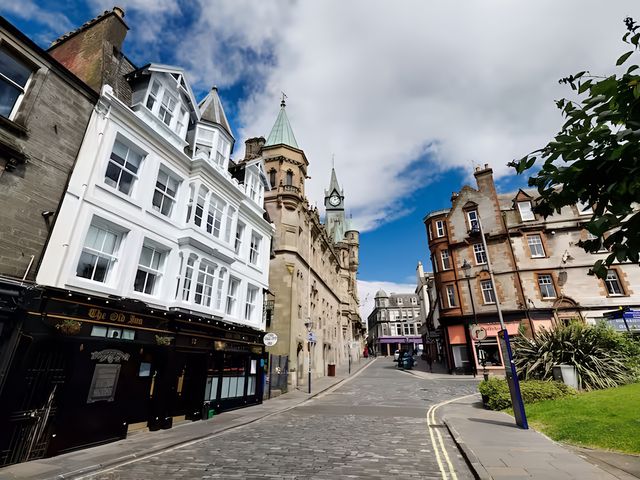 A street view featuring buildings and a clock tower at Robert the Bruce Apartment in Dunfermline