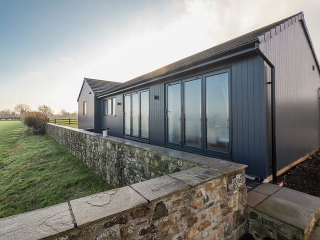 An exterior view of a modern house with large windows at Genesis in Richmond