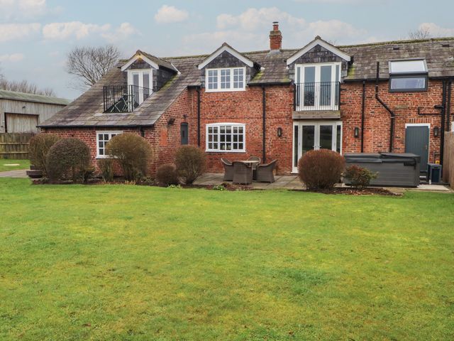 A house with garden and patio furniture at The Winnows in Knutsford