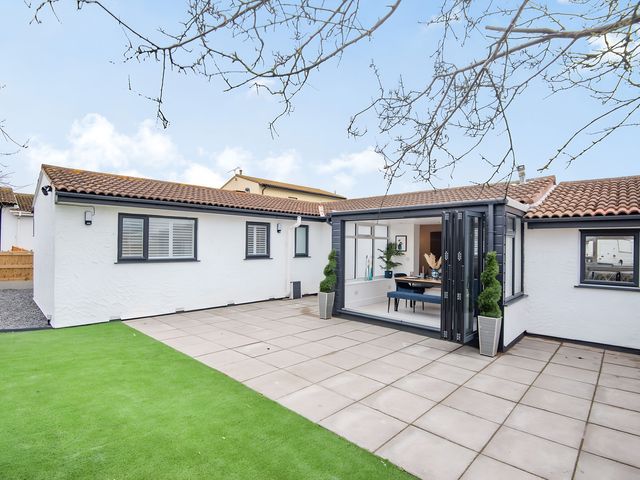 An outdoor area with a house and patio at 6 Tegafan Abergele