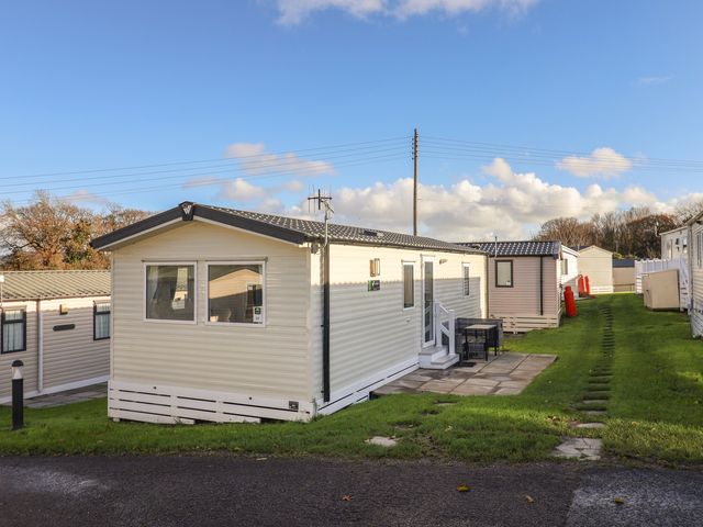 A mobile home with steps and outdoor furniture at WF32 - Jurassic Discovery in Charmouth