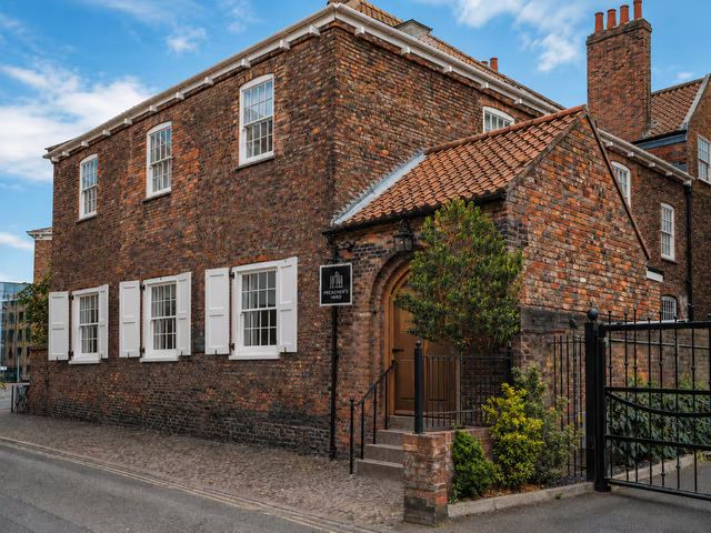 A brick building with windows and a sign at Preachers Yard