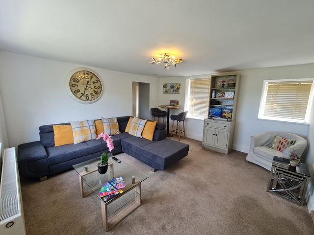 A living room with a sofa and coffee table at Sea view cottage in Penmaenmawr