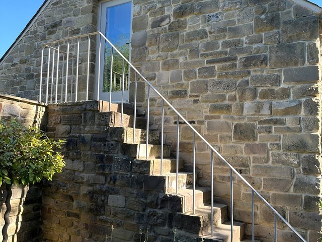 A staircase leading to a door at Hope Valley - Studio in Hope Valley