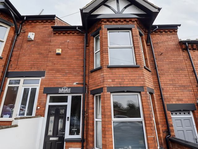 A brick facade with windows and a front door at Love Lane Villa in Lincoln