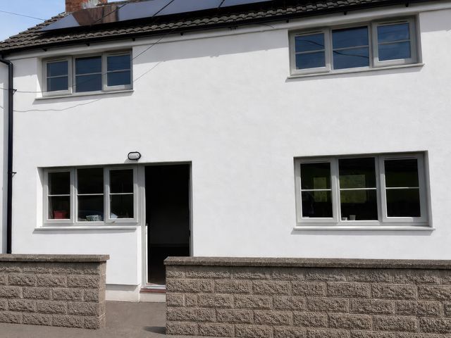 An exterior view of a house with windows and a door at Araelfa in Llwynmawr