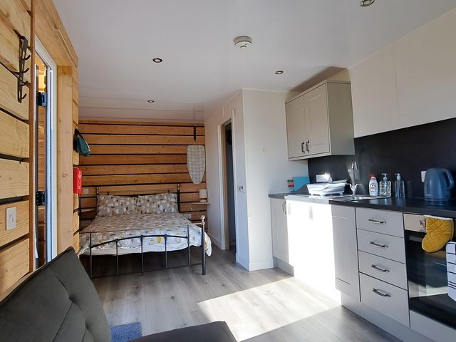 A studio with bed and kitchen area at The Posh Bothy in Roy Bridge