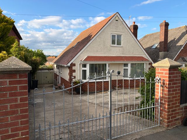 A house with a gate and driveway at Tudor Rose in Weymouth