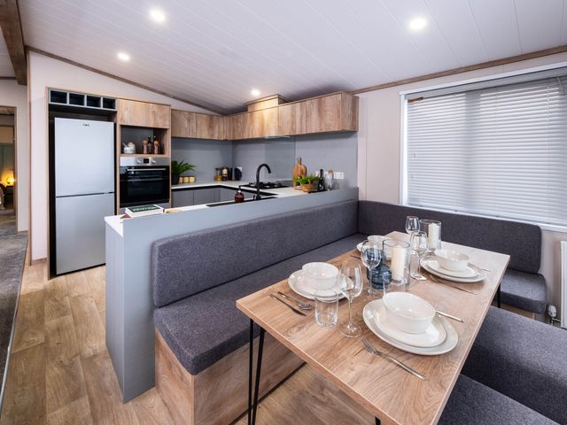 A kitchen with dining area and appliances at No 8 Sandstone Lodge Sanctuary Northwich